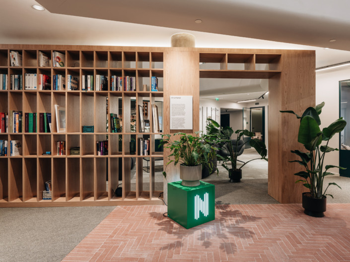 Bookshelf and red herringbone-pattern tiled floor at Nortal office