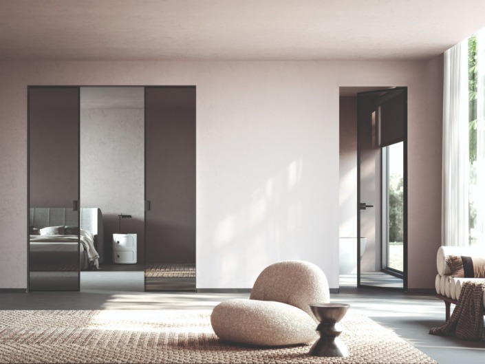ECLISSE aluminium-framed glass sliding and hinged doors in a light-toned interior